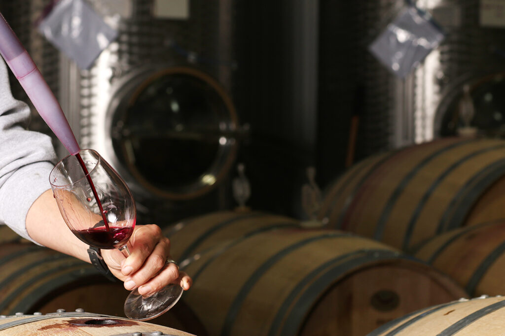 pulling wine from the barrel